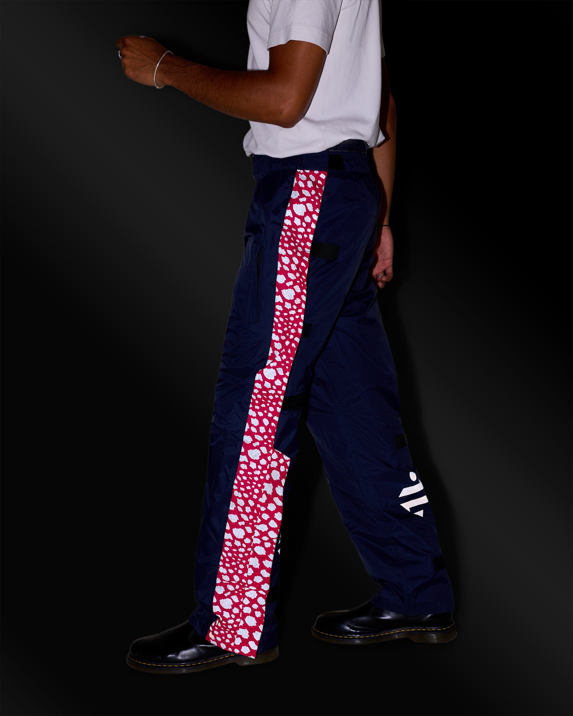pantalon de pluie bleu marine rose à motifs réfléchissants sur homme de nuit