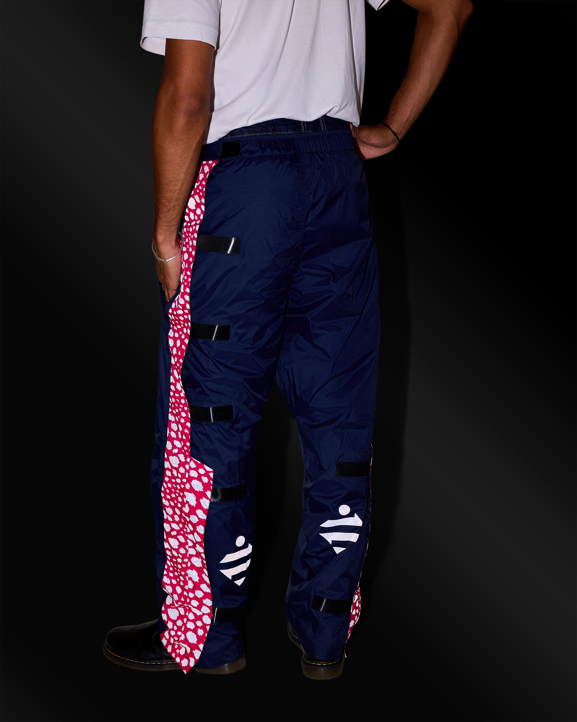 Waterproof rain trousers with reflective patterns and logo